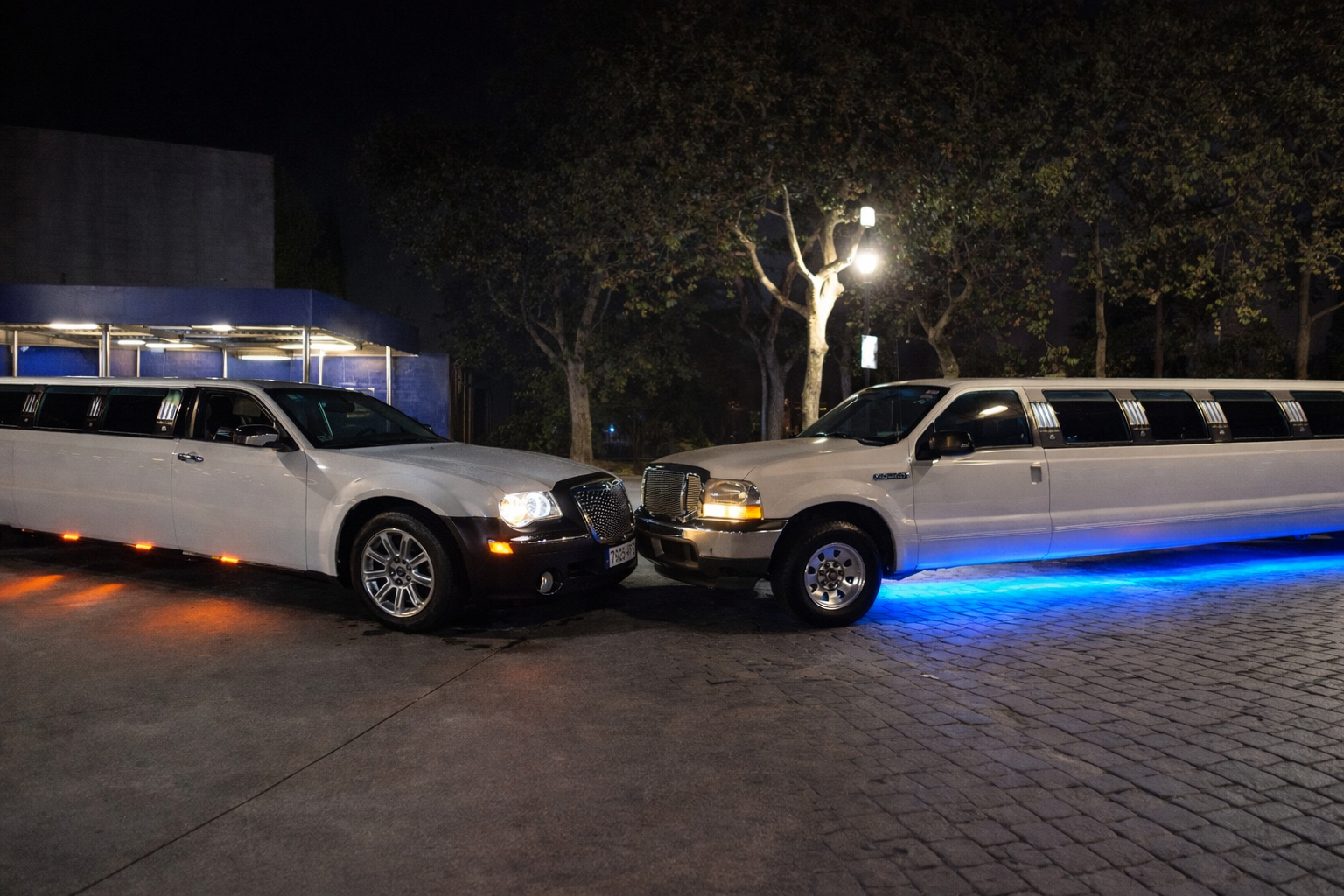 alt="Dos limusinas blancas de lujo en Barcelona con capacidad para 15 personas, perfectas para celebraciones y eventos especiales"